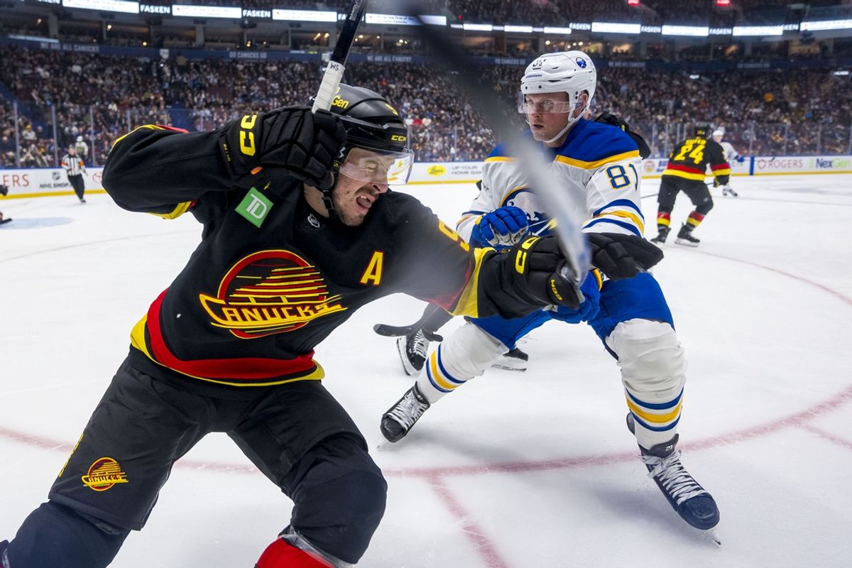 Jan 21, 2025; Vancouver, British Columbia, CAN; Buffalo Sabres forward Sam Lafferty (81) checks Vancouver Canucks forward J.T. Miller (9) in the first period at Rogers Arena. Mandatory Credit: Bob Frid-Imagn Images