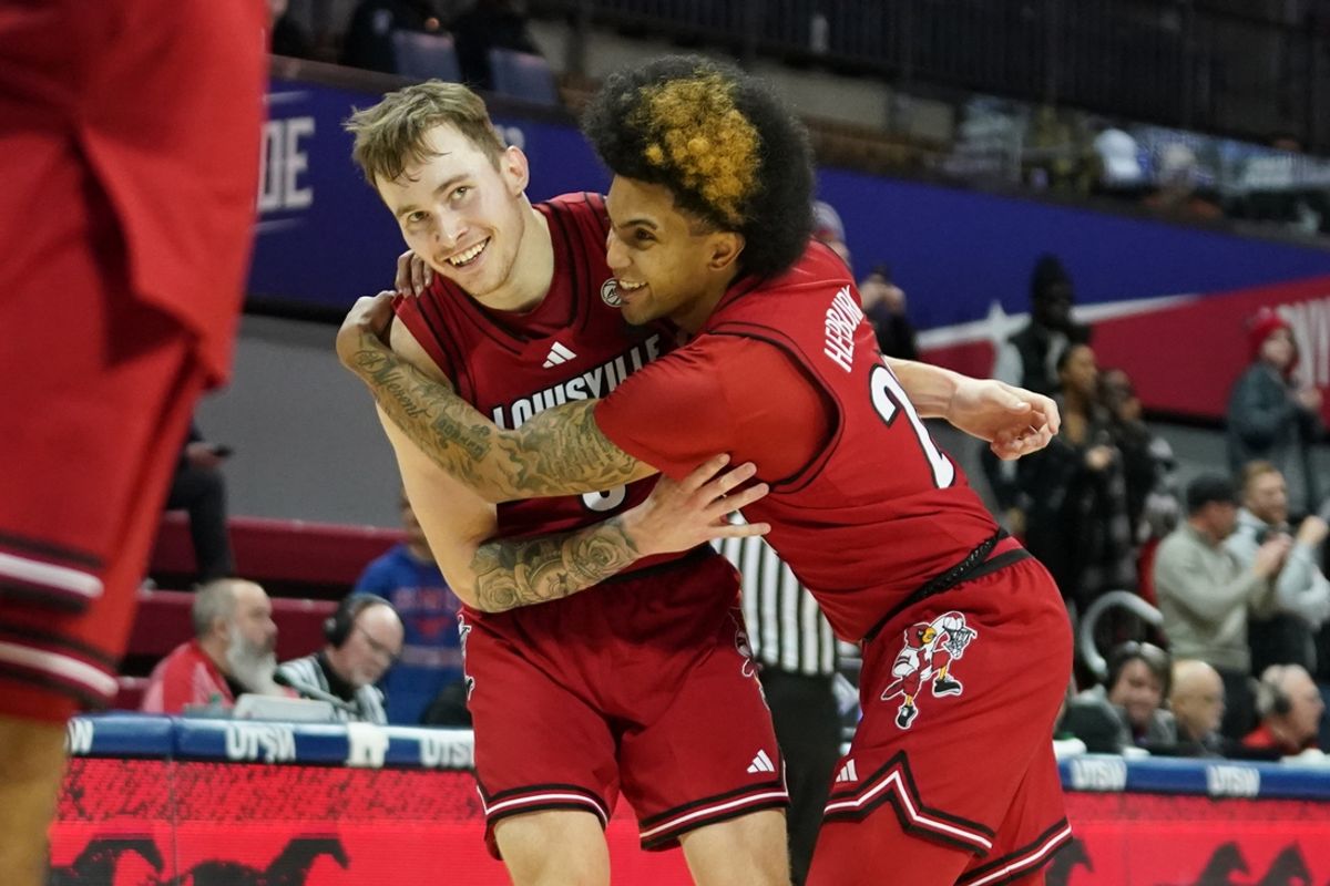 Jan 21, 2025; Dallas, Texas, USA; Louisville Cardinals guard Reyne Smith (6) is hugged by guard Chucky Hepburn (24) after a made three-point basket against the SMU Mustangs during the second half at Moody Coliseum. Mandatory Credit: Raymond Carlin III-Imagn Images