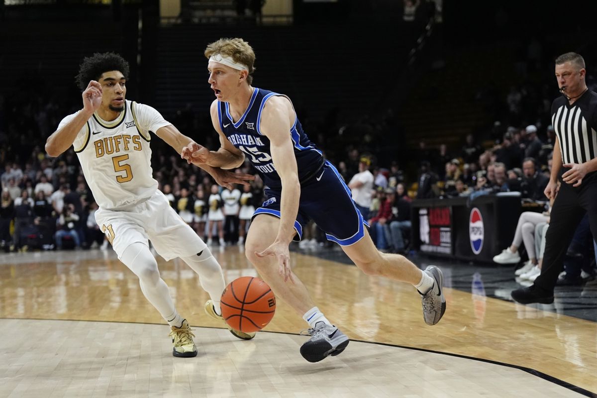 Jan 21, 2025; Boulder, Colorado, USA; Brigham Young Cougars forward Richie Saunders (15) drives against Colorado Buffaloes guard RJ Smith (5) in the first half at CU Events Center. Mandatory Credit: Ron Chenoy-Imagn Images