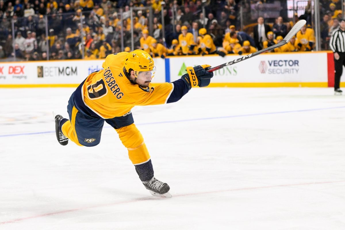 Jan 21, 2025; Nashville, Tennessee, USA;  Nashville Predators left wing Filip Forsberg (9) takes a shot on goal against the San Jose Sharks during the third period at Bridgestone Arena. Mandatory Credit: Steve Roberts-Imagn Images