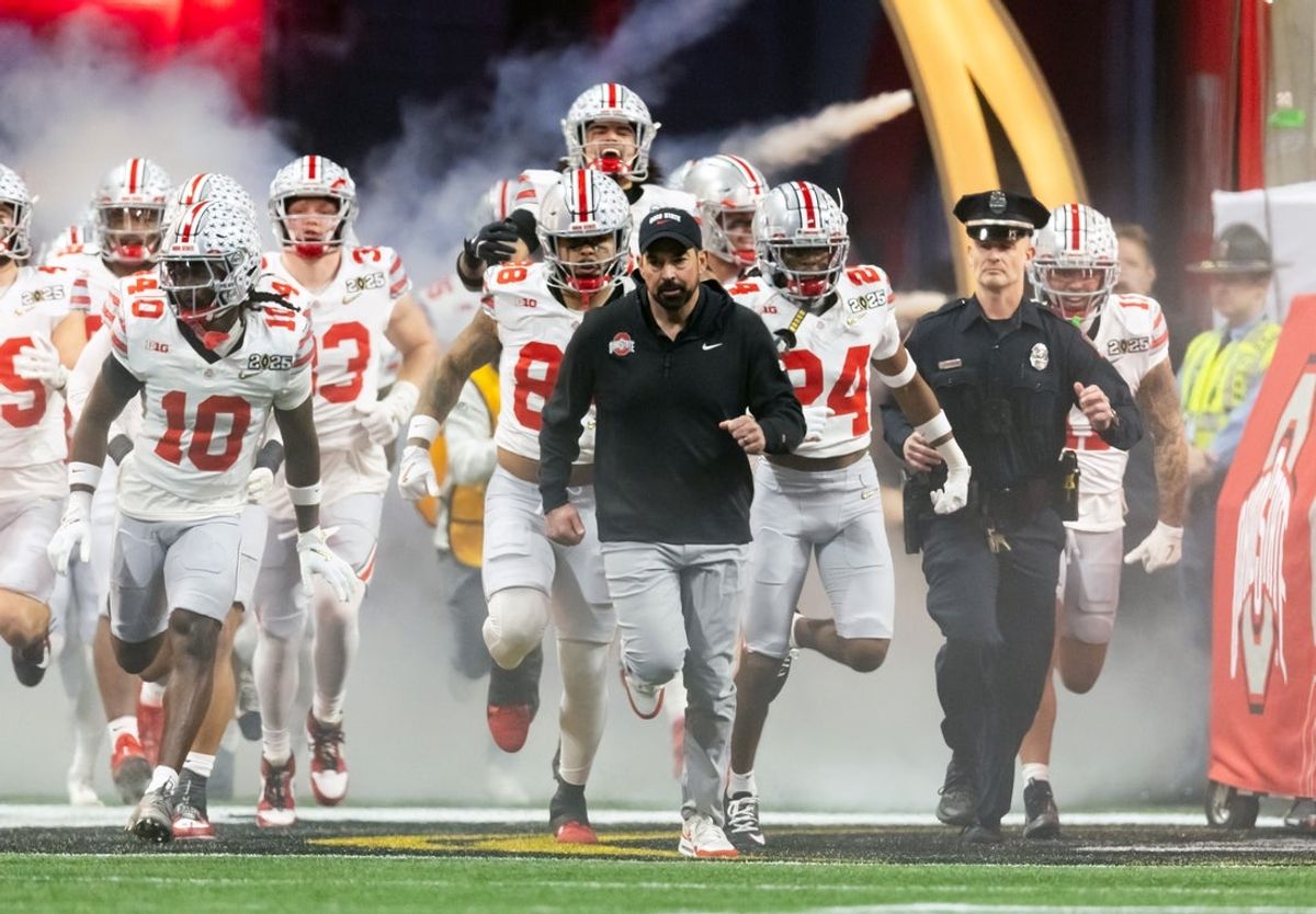 Jan 20, 2025; Atlanta, GA, USA; Ohio State Buckeyes head coach Ryan Day leads his team onto the field for the game against the Notre Dame Fighting Irish during the CFP National Championship college football game at Mercedes-Benz Stadium. Mandatory Credit: Mark J. Rebilas-Imagn Images