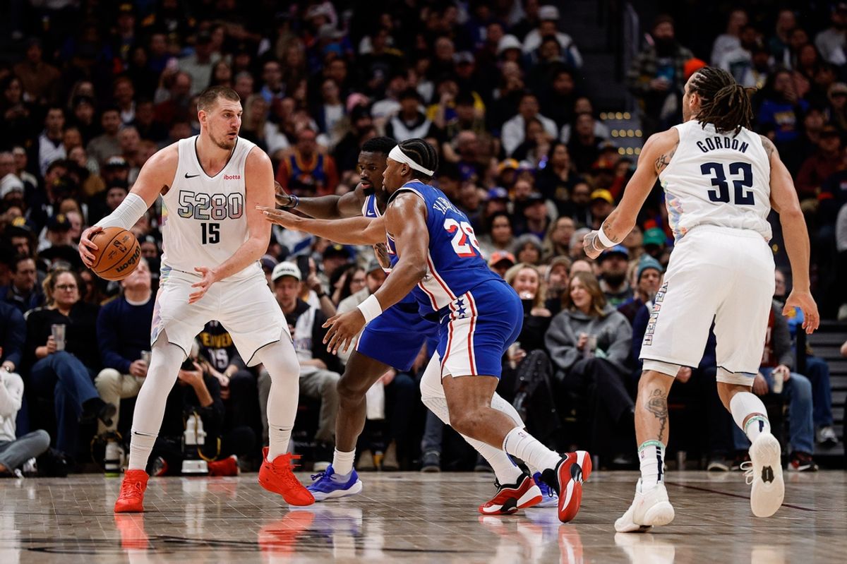 Jan 21, 2025; Denver, Colorado, USA; Denver Nuggets center Nikola Jokic (15) controls the ball under pressure from Philadelphia 76ers forward Guerschon Yabusele (28) and center Adem Bona (30) as forward Aaron Gordon (32) defends in the third quarter at Ball Arena. Mandatory Credit: Isaiah J. Downing-Imagn Images