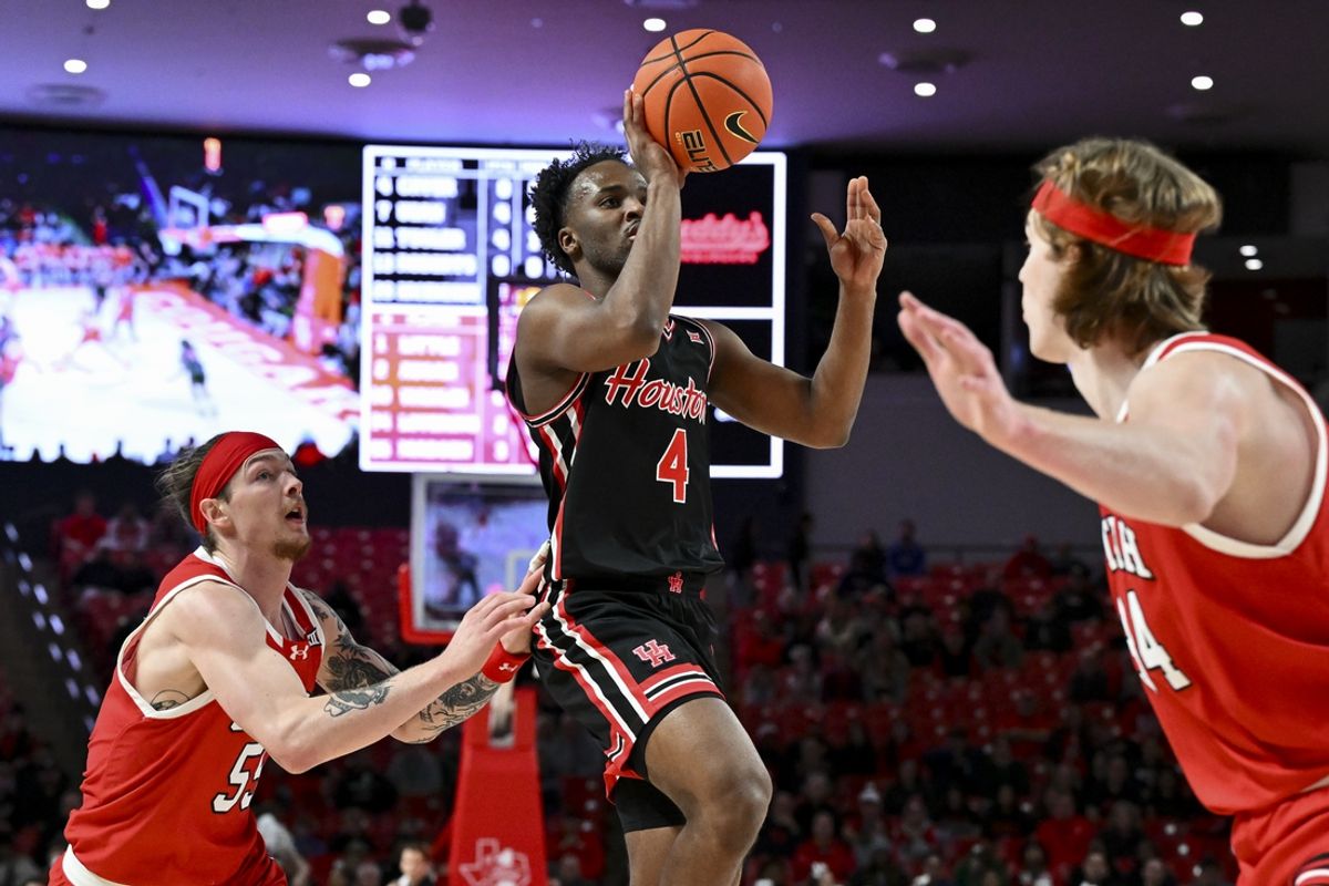 Jan 22, 2025; Houston, Texas, USA; Houston Cougars guard L.J. Cryer (4) drives to the basket past Utah Utes guard Gabe Madsen (55) during the first half at Fertitta Center. Mandatory Credit: Maria Lysaker-Imagn Images