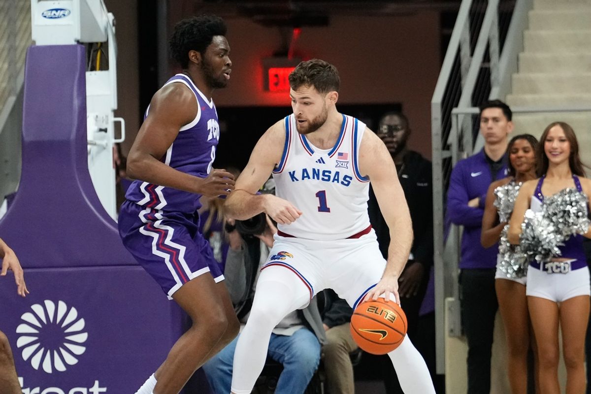 Jan 22, 2025; Fort Worth, Texas, USA;  Kansas Jayhawks center Hunter Dickinson (1) controls the ball as TCU Horned Frogs center Ernest Udeh Jr. (8) defends during the first half at Ed and Rae Schollmaier Arena. Mandatory Credit: Chris Jones-Imagn Images