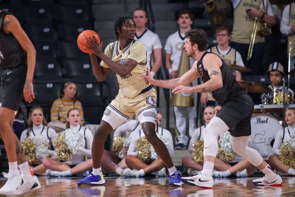 Jan 22, 2025; Atlanta, Georgia, USA; Georgia Tech Yellow Jackets forward Baye Ndongo (11) is defended by Virginia Tech Hokies forward Ben Burnham (13) in the first half at McCamish Pavilion. Mandatory Credit: Brett Davis-Imagn Images