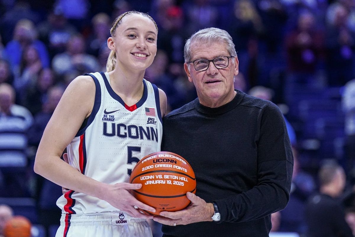 Jan 22, 2025; Storrs, Connecticut, USA; UConn Huskies guard Paige Bueckers (5) is recognized with head coach Geno Auriemma for her 2000 career points before the start of the game against the Villanova Wildcats at Harry A. Gampel Pavilion. Mandatory Credit: David Butler II-Imagn Images