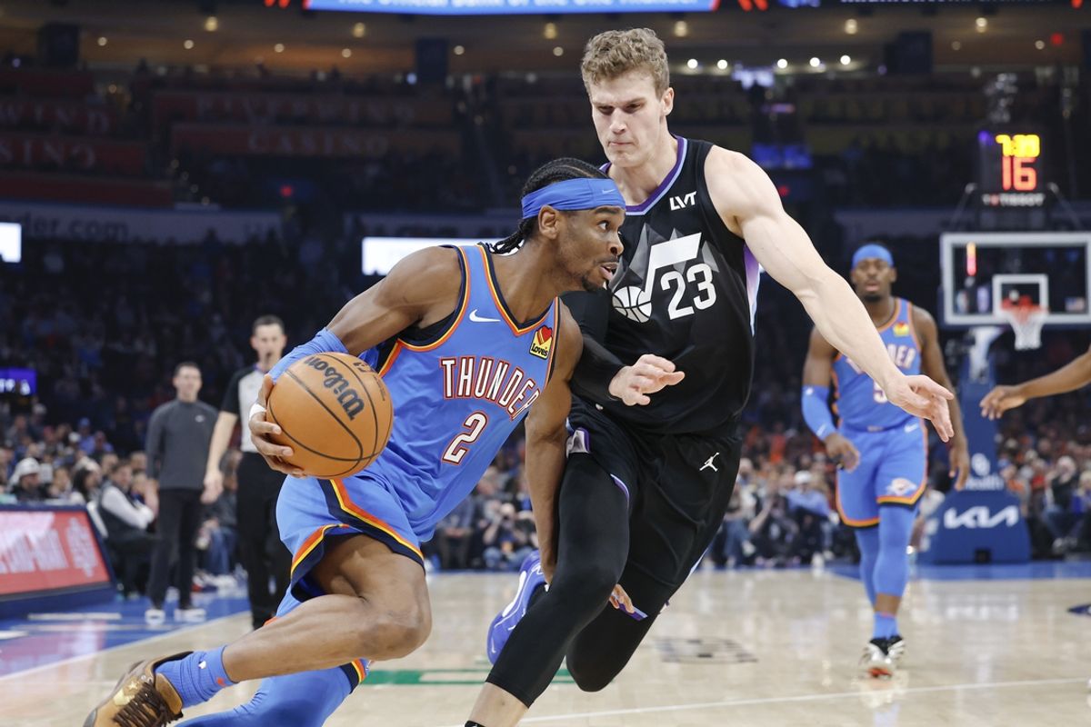 Jan 22, 2025; Oklahoma City, Oklahoma, USA; Oklahoma City Thunder guard Shai Gilgeous-Alexander (2) drives around Utah Jazz forward Lauri Markkanen (23) during the first quarter at Paycom Center. Mandatory Credit: Alonzo Adams-Imagn Images