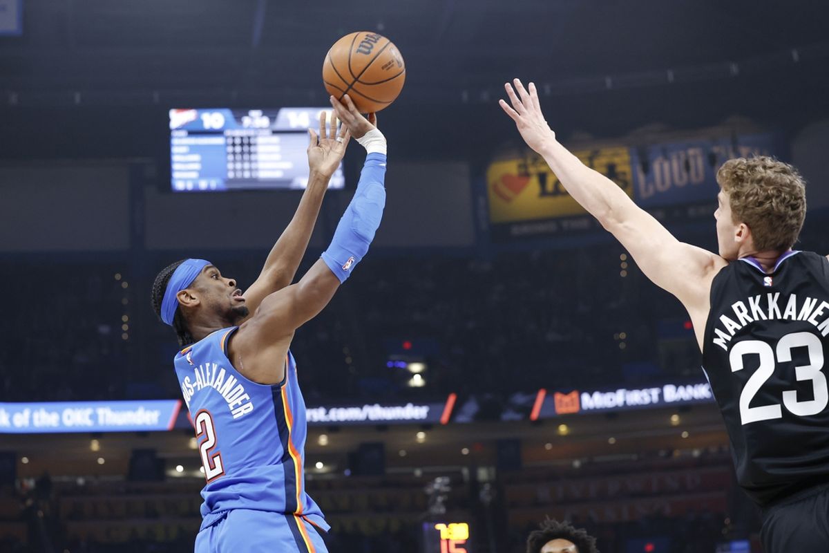Jan 22, 2025; Oklahoma City, Oklahoma, USA; Oklahoma City Thunder guard Shai Gilgeous-Alexander (2) shoots as Utah Jazz forward Lauri Markkanen (23) defends during the first quarter at Paycom Center. Mandatory Credit: Alonzo Adams-Imagn Images