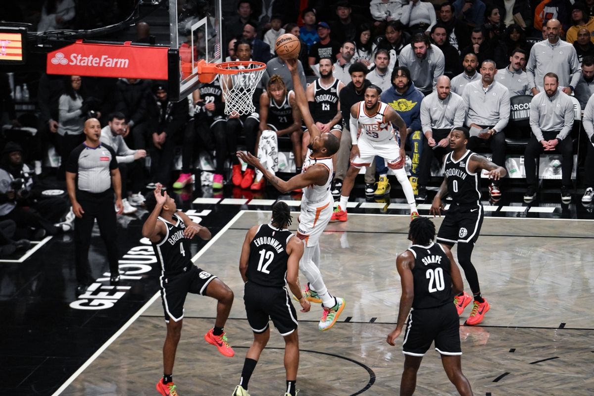 Jan 22, 2025; Brooklyn, New York, USA; Phoenix Suns forward Kevin Durant (35) shoots the ball against Brooklyn Nets guard Reece Beekman (4) and Brooklyn Nets forward Tosan Evbuomwan (12) during the first half at Barclays Center. Mandatory Credit: John Jones-Imagn Images