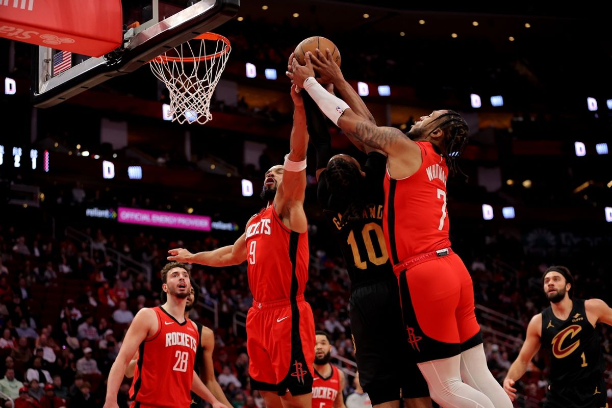 Jan 22, 2025; Houston, Texas, USA; Cleveland Cavaliers guard Darius Garland (10) battles Houston Rockets forward Dillon Brooks (9) and guard Cam Whitmore (7) for a rebound during the first quarter at Toyota Center. Mandatory Credit: Erik Williams-Imagn Images