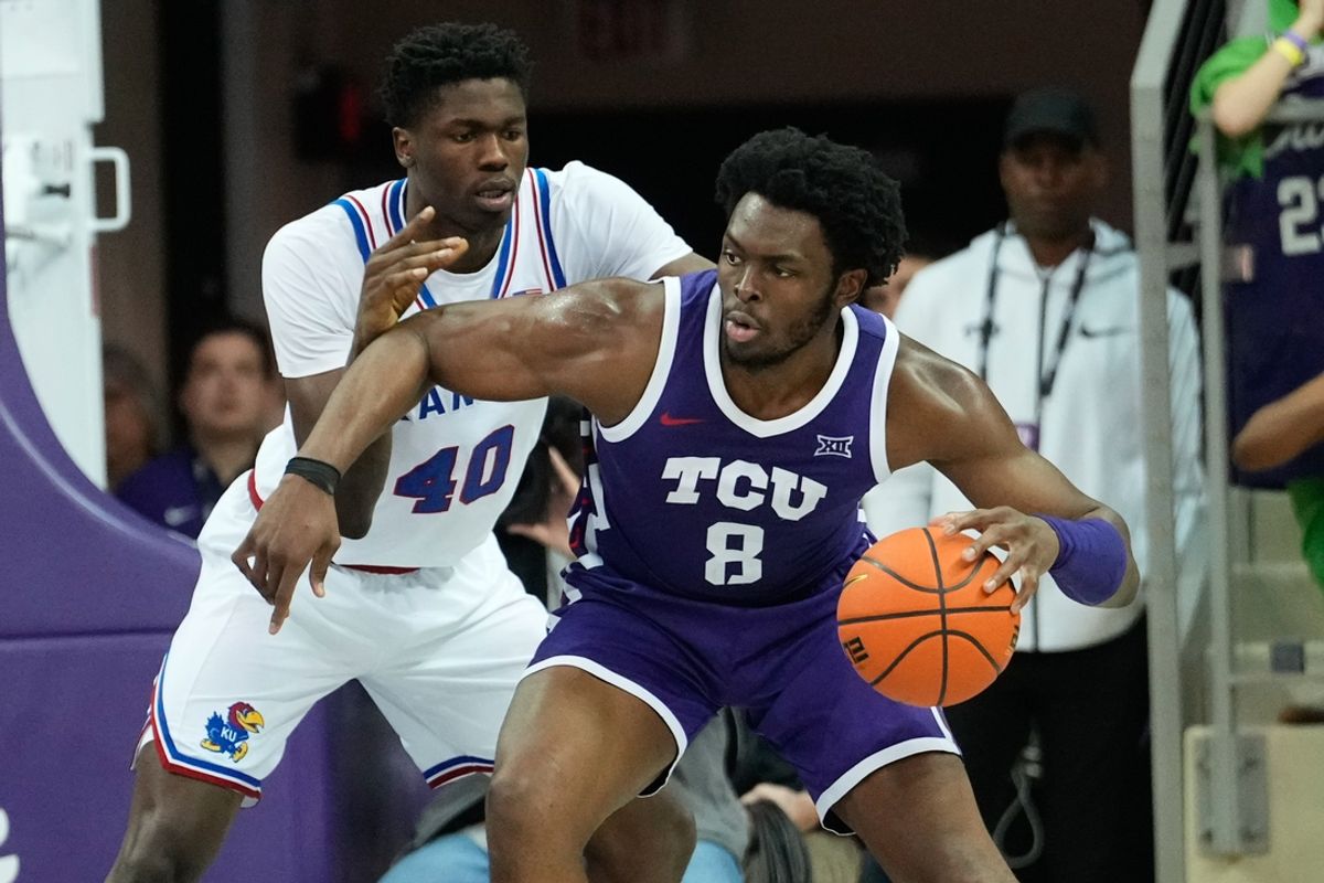 Jan 22, 2025; Fort Worth, Texas, USA;  TCU Horned Frogs center Ernest Udeh Jr. (8) controls the ball as Kansas Jayhawks forward Flory Bidunga (40) defends during the second half at Ed and Rae Schollmaier Arena. Mandatory Credit: Chris Jones-Imagn Images