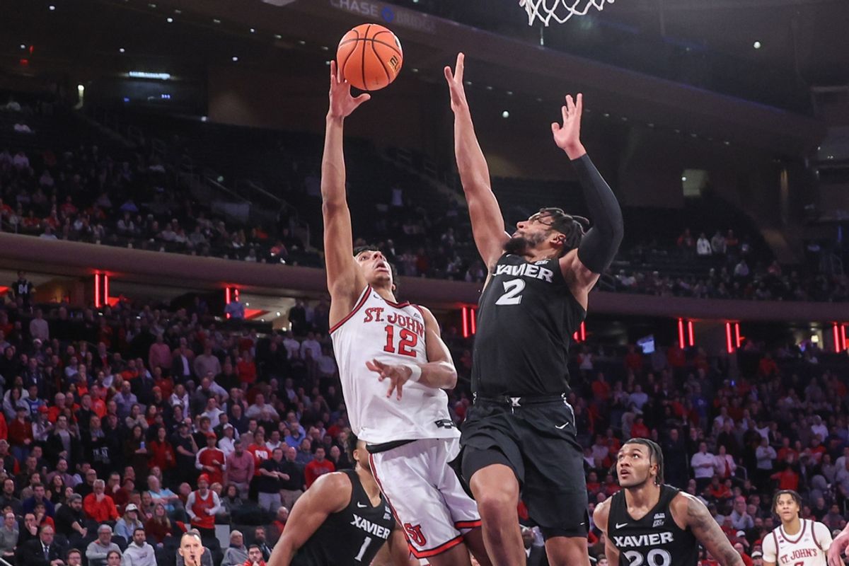 Jan 22, 2025; New York, New York, USA;  St. John's Red Storm guard RJ Luis Jr. (12) shoots over Xavier Musketeers forward Jerome Hunter (2) in overtime at Madison Square Garden. Mandatory Credit: Wendell Cruz-Imagn Images