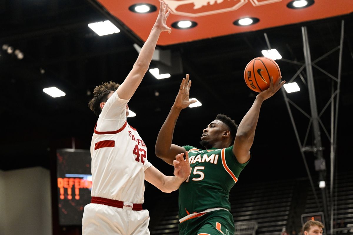 Jan 22, 2025; Stanford, California, USA; Miami (FL) Hurricanes forward Kiree Huie (15) attempts a basket against Stanford Cardinal forward Maxime Raynaud (42) in the first half at Maples Pavilion. Mandatory Credit: Eakin Howard-Imagn Images