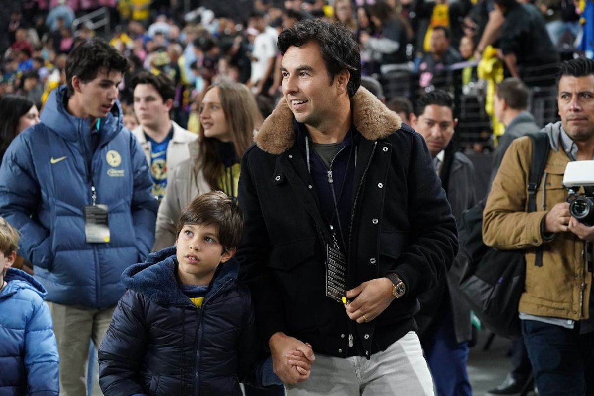 Jan 18, 2025; Las Vegas, Nevada, USA;  Former Formula 1 driver Sergio Perez enters the field as a guest of Club America prior to America's match against Inter Miami CF at Allegiant Stadium. Mandatory Credit: David Gonzales-Imagn Images