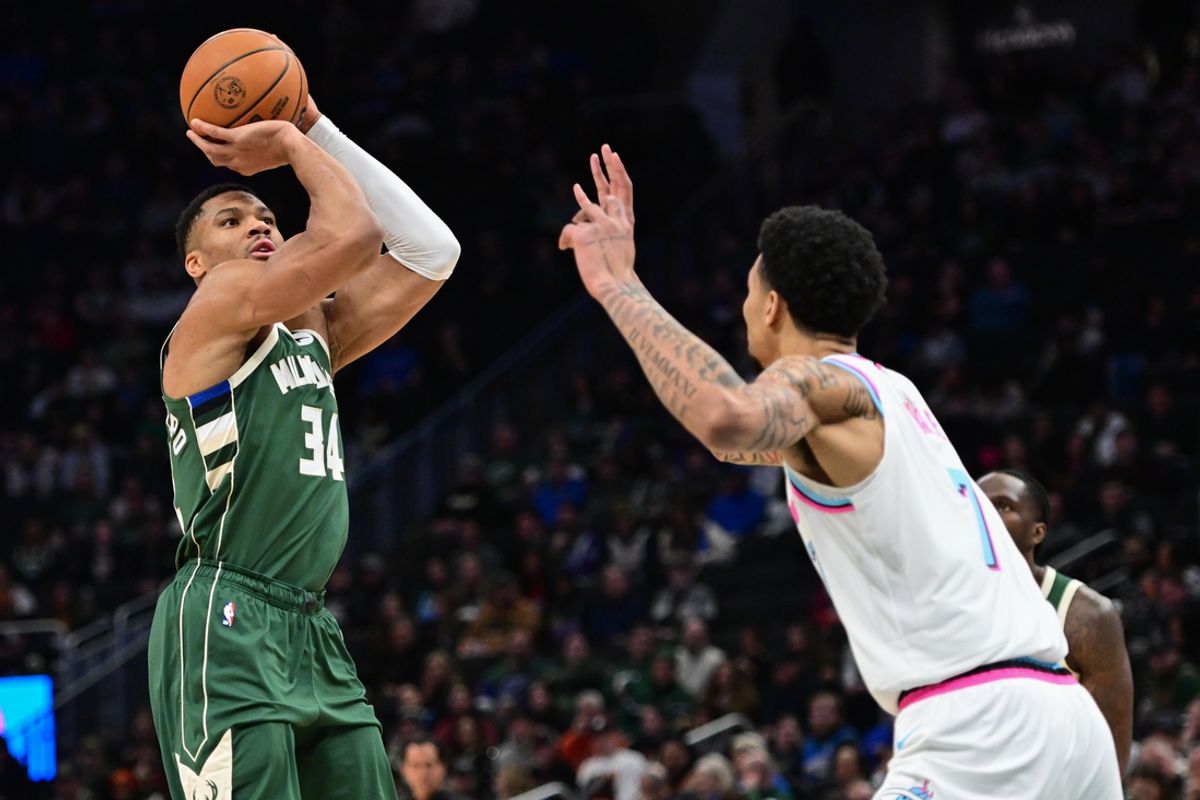 Jan 23, 2025; Milwaukee, Wisconsin, USA;  Milwaukee Bucks forward Giannis Antetokounmpo (34) takes a shot against Miami Heat center Kel'el Ware (7) in the first quarter at Fiserv Forum. Mandatory Credit: Benny Sieu-Imagn Images