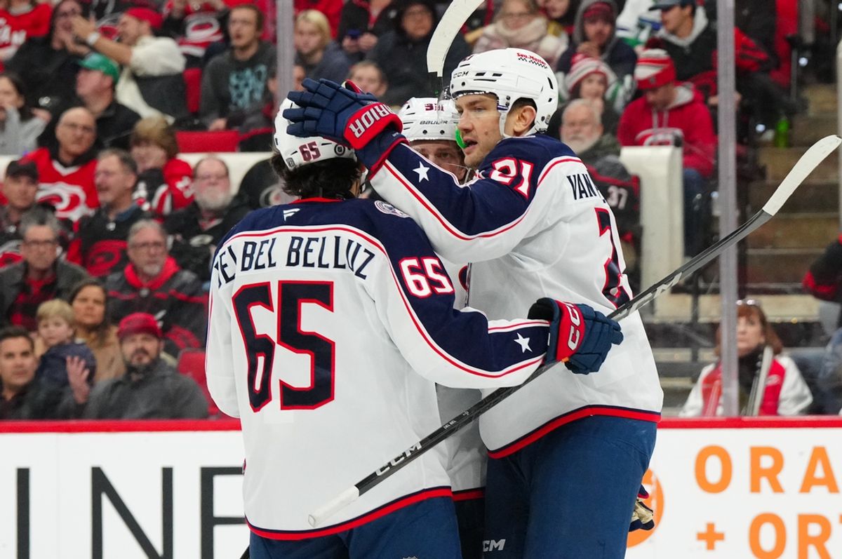 Jan 23, 2025; Raleigh, North Carolina, USA;  Columbus Blue Jackets left wing James van Riemsdyk (21) is congratulated by center Luca Del Bel Belluz (65) after his goal against the Carolina Hurricanes during the second period at Lenovo Center. Mandatory Credit: James Guillory-Imagn Images