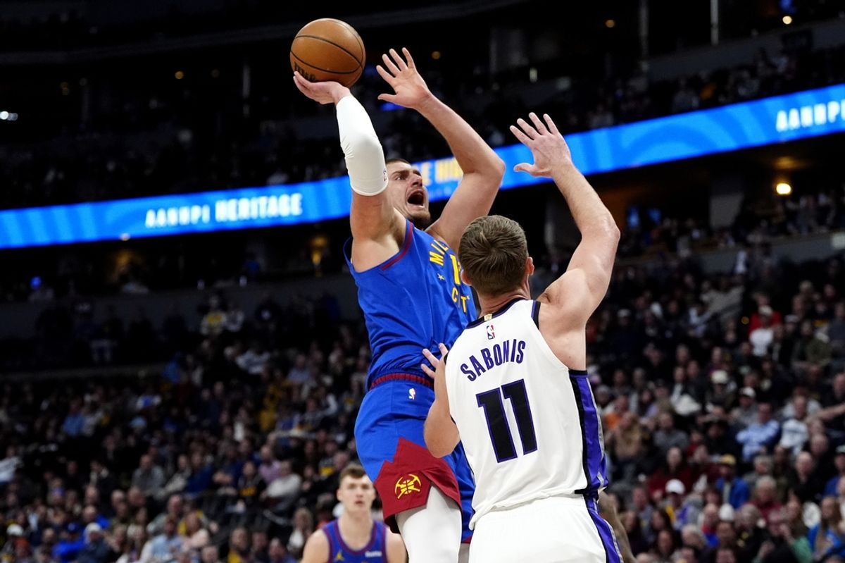 Jan 23, 2025; Denver, Colorado, USA; Denver Nuggets center Nikola Jokic (15) shoots over Sacramento Kings forward Domantas Sabonis (11) in the first quarter at Ball Arena. Mandatory Credit: Ron Chenoy-Imagn Images