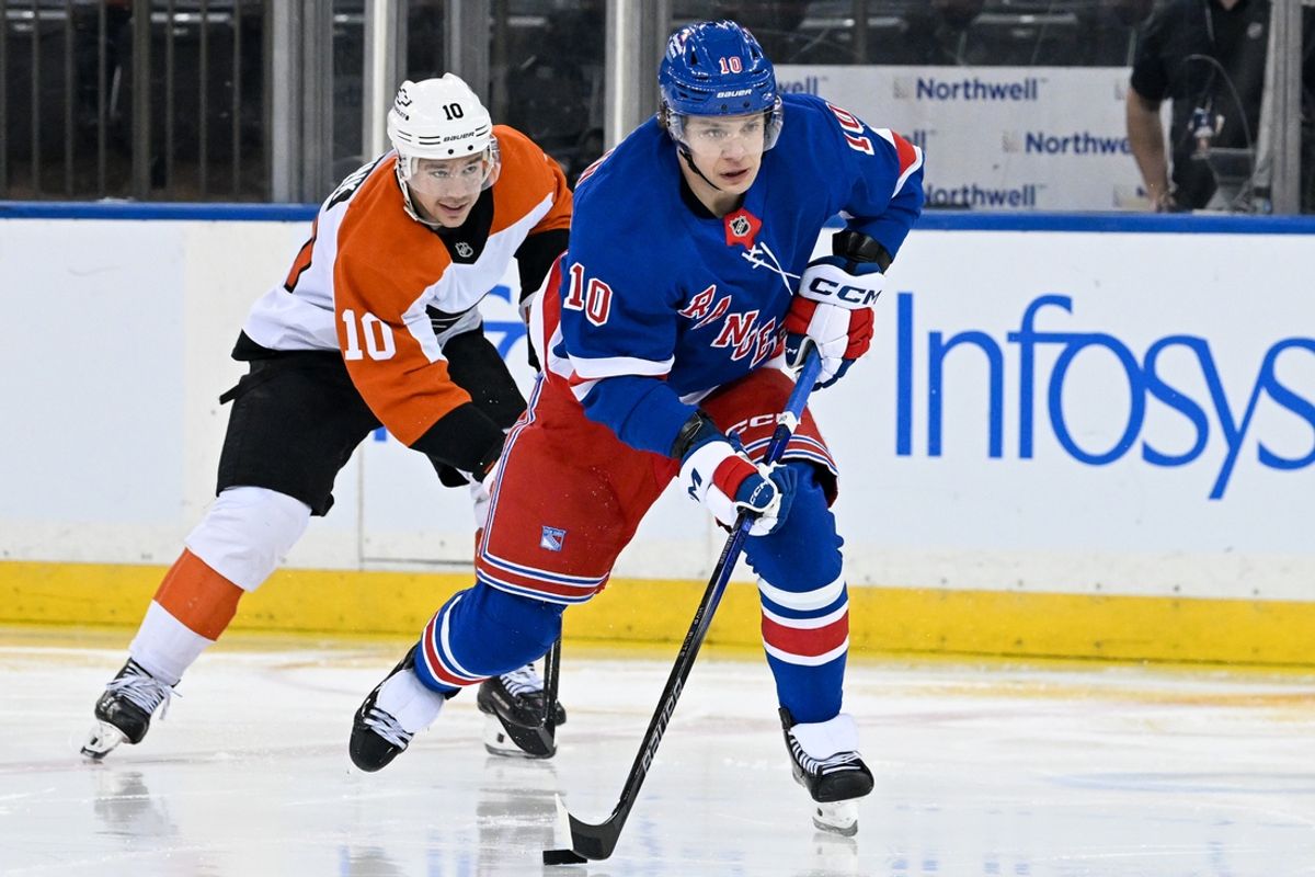 Jan 23, 2025; New York, New York, USA;  New York Rangers left wing Artemi Panarin (10) skates with the puck chased by Philadelphia Flyers right wing Bobby Brink (10) during the third period at Madison Square Garden. Mandatory Credit: Dennis Schneidler-Imagn Images