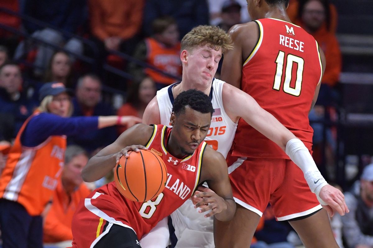 Jan 23, 2025; Champaign, Illinois, USA;  Maryland Terrapins guard Jay Young (8) drives the ball past Illinois Fighting Illini guard Kasparas Jakucionis (32) during the first half at State Farm Center. Mandatory Credit: Ron Johnson-Imagn Images