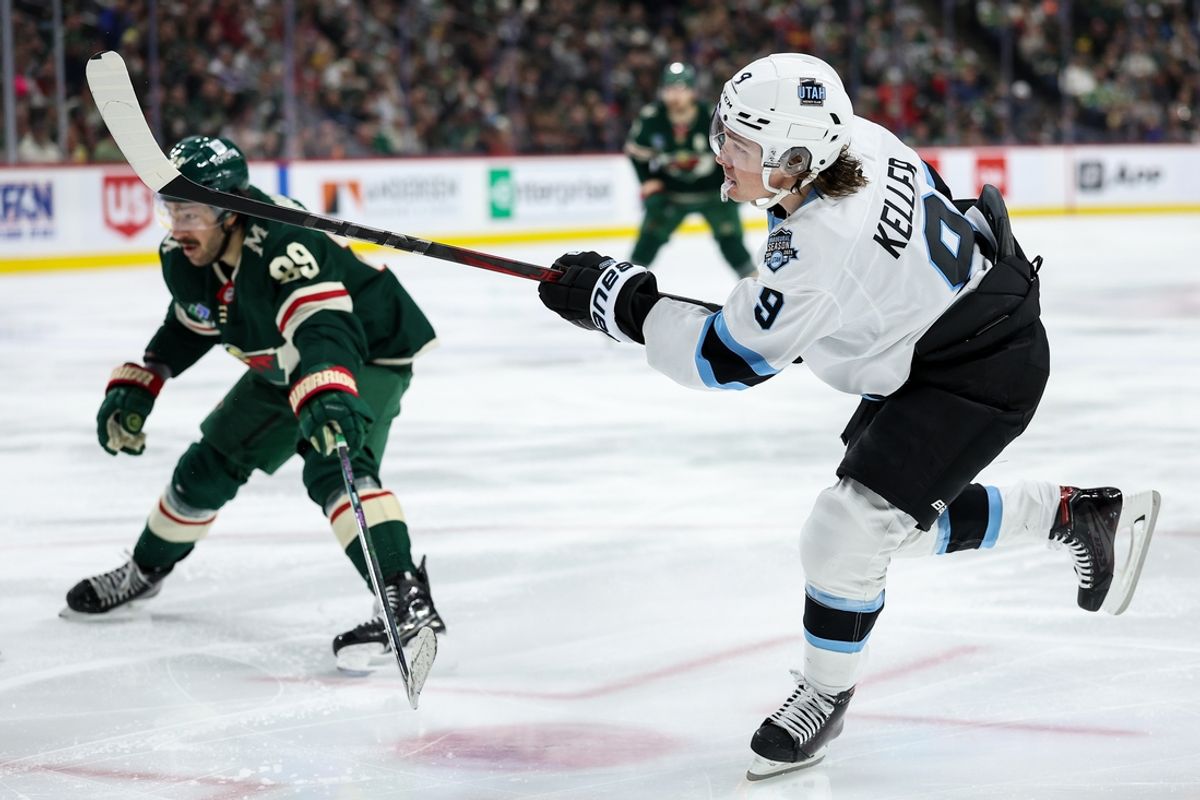 Jan 23, 2025; Saint Paul, Minnesota, USA; Utah Hockey Club center Clayton Keller (9) shoots as Minnesota Wild center Frederick Gaudreau (89) defends during the third period at Xcel Energy Center. Mandatory Credit: Matt Krohn-Imagn Images