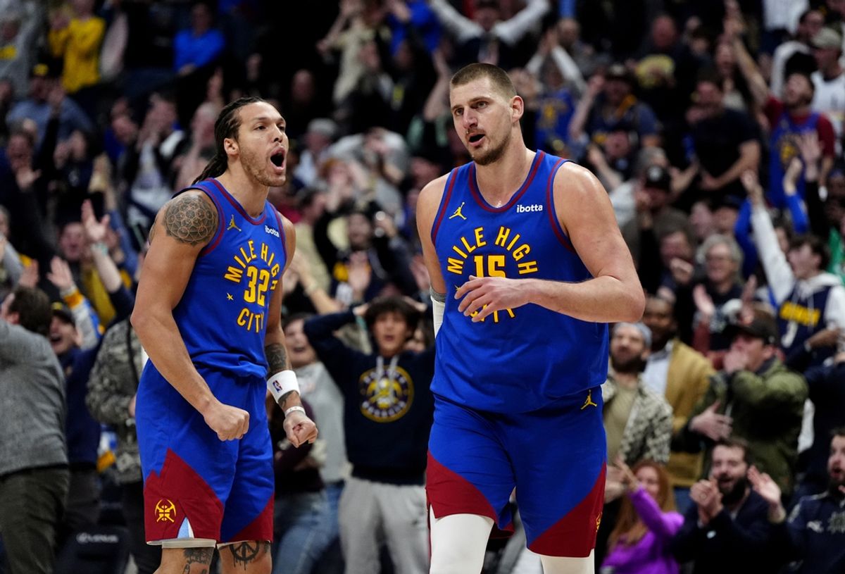 Jan 23, 2025; Denver, Colorado, USA; Denver Nuggets center Nikola Jokic (15) reacts along side forward Aaron Gordon (32)  following a full court basket made in the second half against the Sacramento Kings at Ball Arena. Mandatory Credit: Ron Chenoy-Imagn Images