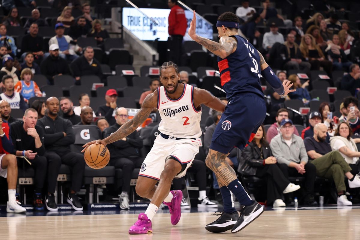 Jan 23, 2025; Inglewood, California, USA;  Los Angeles Clippers forward Kawhi Leonard (2) drives against Washington Wizards forward Kyle Kuzma (33) during the first quarter at Intuit Dome. Mandatory Credit: Kiyoshi Mio-Imagn Images