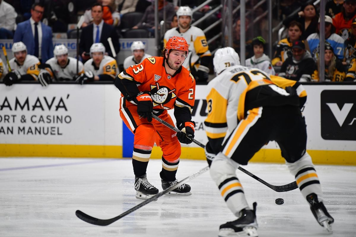 Jan 23, 2025; Anaheim, California, USA; Anaheim Ducks center Mason McTavish (23) moves the puck against Pittsburgh Penguins defenseman P.O Joseph (73) during the third period at Honda Center. Mandatory Credit: Gary A. Vasquez-Imagn Images