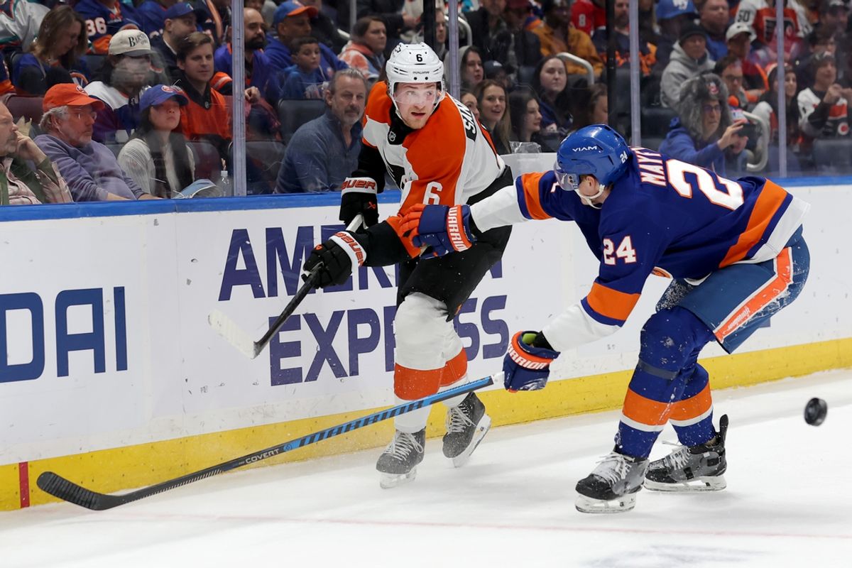 Jan 24, 2025; Elmont, New York, USA; Philadelphia Flyers defenseman Travis Sanheim (6) plays the puck past New York Islanders defenseman Scott Mayfield (24) during the first period at UBS Arena. Mandatory Credit: Brad Penner-Imagn Images