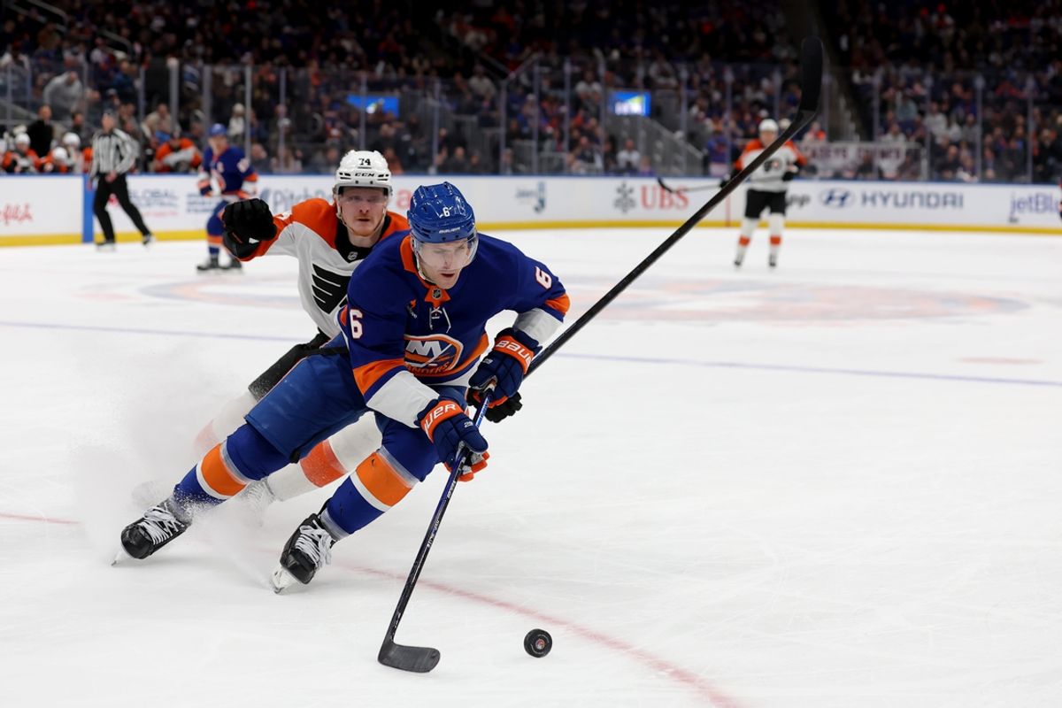 Jan 24, 2025; Elmont, New York, USA; New York Islanders defenseman Ryan Pulock (6) plays the puck against Philadelphia Flyers right wing Owen Tippett (74) during the first period at UBS Arena. Mandatory Credit: Brad Penner-Imagn Images