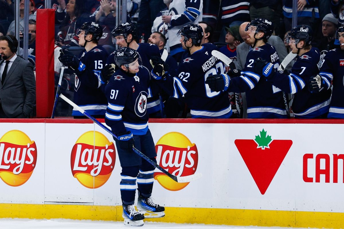 Jan 24, 2025; Winnipeg, Manitoba, CAN;  Winnipeg Jets forward Cole Perfetti (91) is congratulated by his teammates on his goal against the Utah Hockey Club during the first period at Canada Life Centre. Mandatory Credit: Terrence Lee-Imagn Images