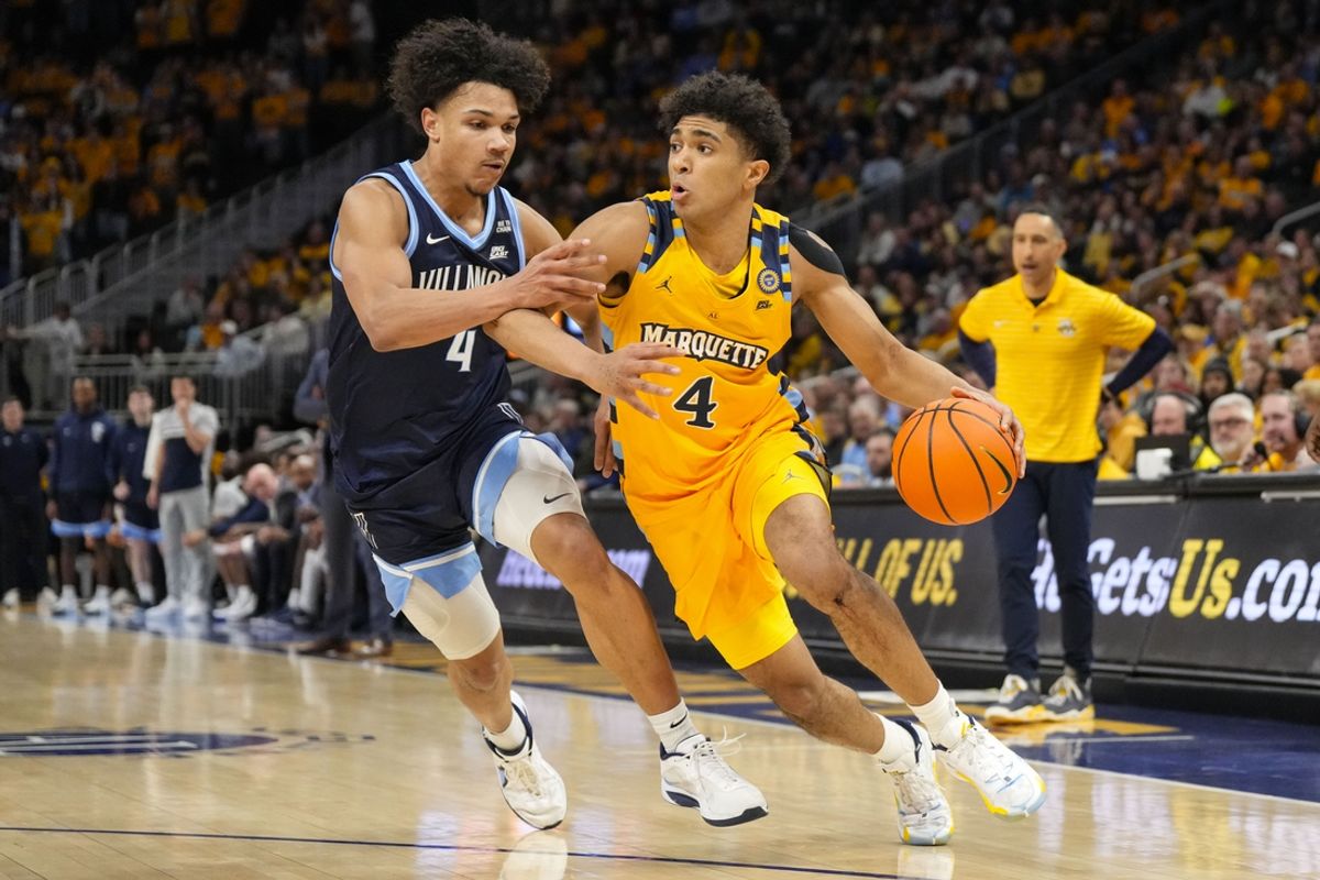 Jan 24, 2025; Milwaukee, Wisconsin, USA;  Marquette Golden Eagles guard Stevie Mitchell (4) drives for the basket against Villanova Wildcats guard Tyler Perkins (4) during the second half at Fiserv Forum. Mandatory Credit: Jeff Hanisch-Imagn Images