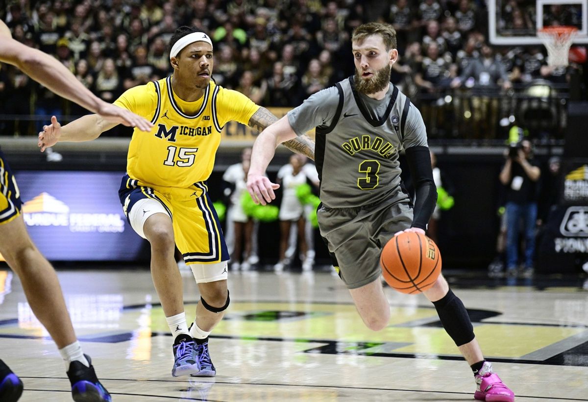 Jan 24, 2025; West Lafayette, Indiana, USA; Purdue Boilermakers guard Braden Smith (3) drives the ball down court past Michigan Wolverines guard Rubin Jones (15) during the second half at Mackey Arena. Mandatory Credit: Marc Lebryk-Imagn Images