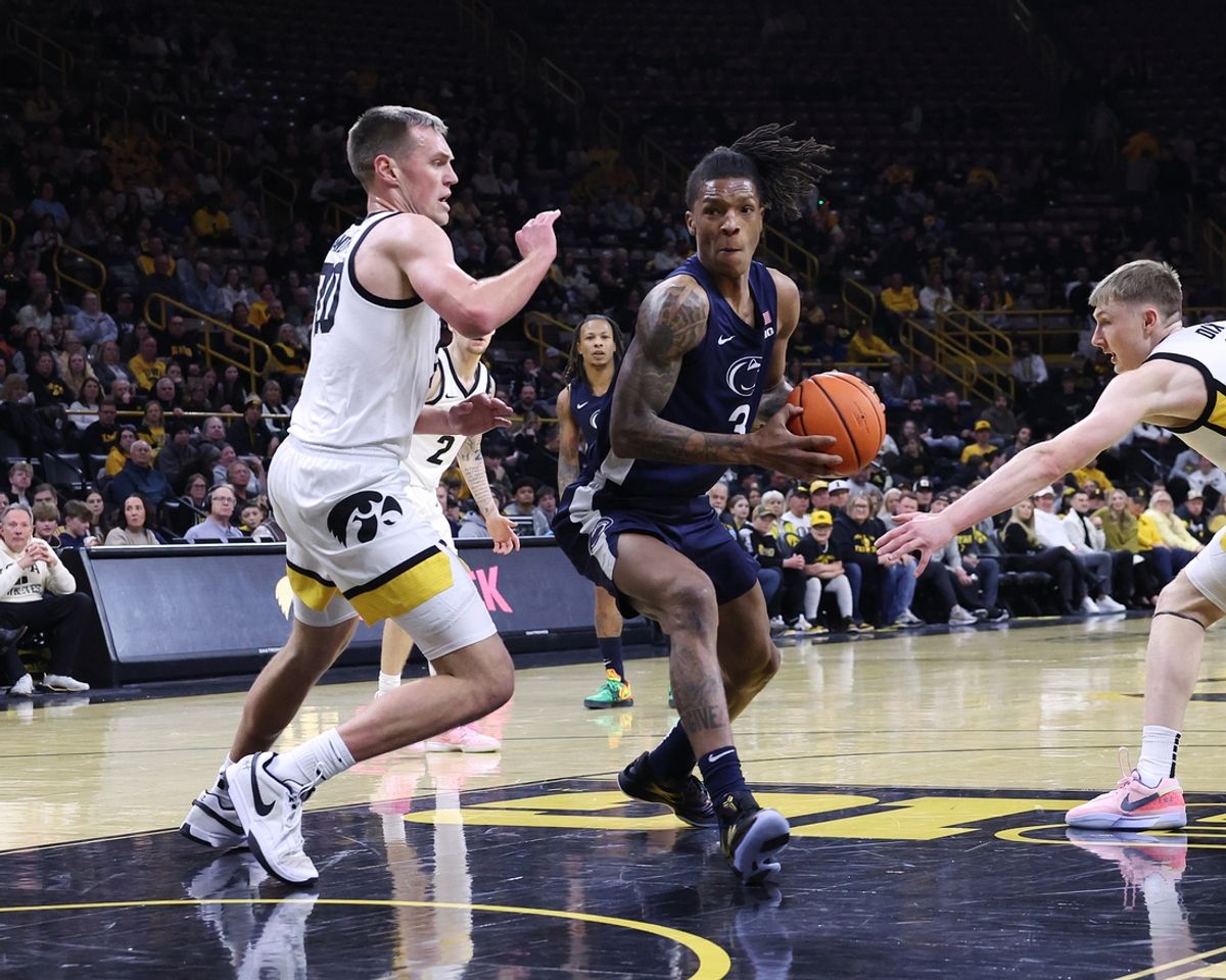Jan 24, 2025; Iowa City, Iowa, USA; Iowa Hawkeyes forward Payton Sandfort (20) defends Penn State Nittany Lions guard Nick Kern Jr. (3) during the first half at Carver-Hawkeye Arena. Mandatory Credit: Reese Strickland-Imagn Images