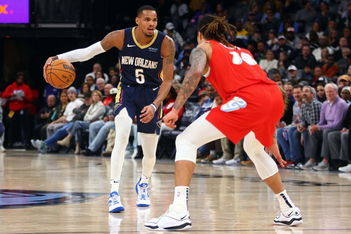 Jan 24, 2025; Memphis, Tennessee, USA; New Orleans Pelicans guard Dejounte Murray (5) dribbles as Memphis Grizzlies forward Brandon Clarke (15) defends during the third quarter at FedExForum. Mandatory Credit: Petre Thomas-Imagn Images