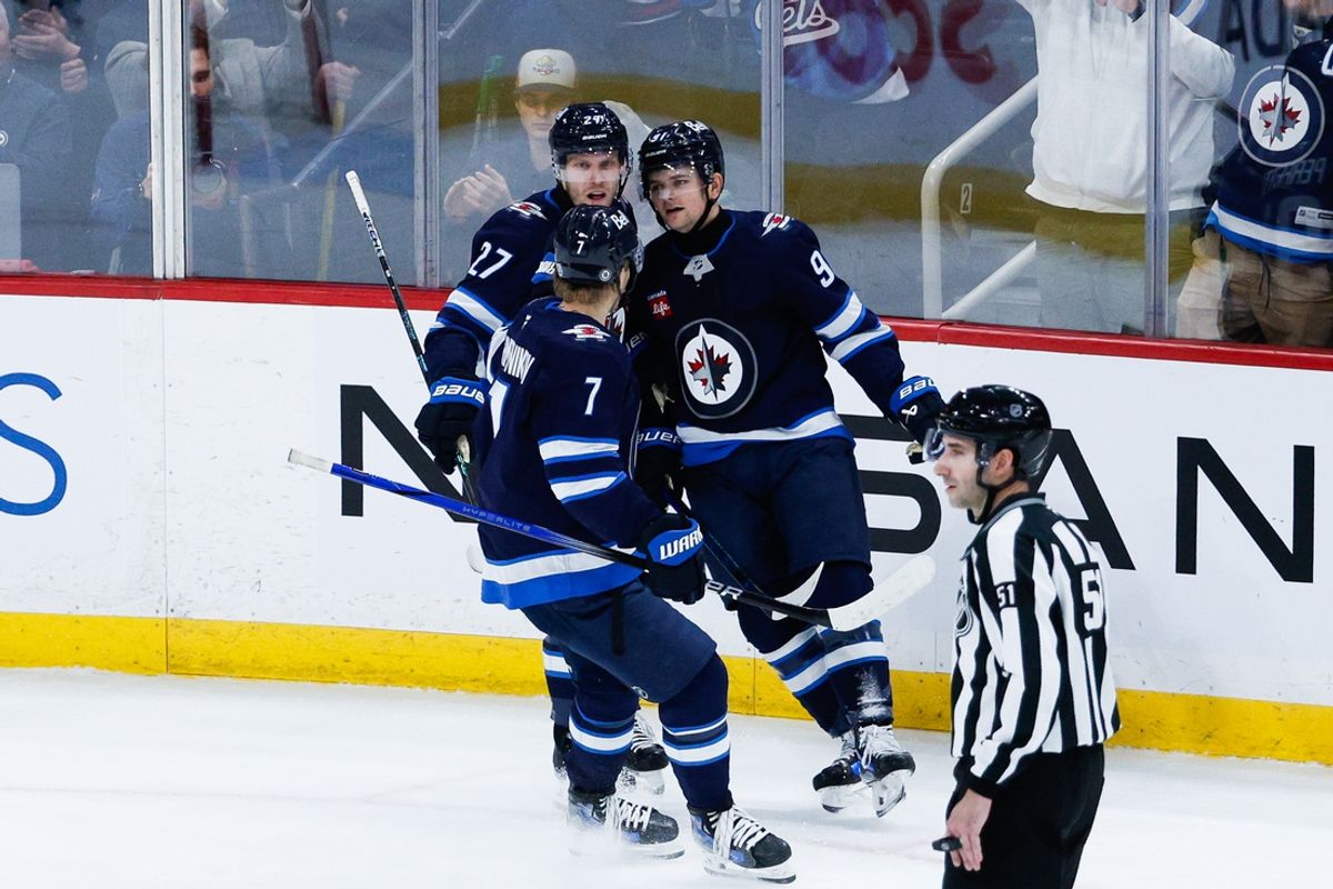 Jan 24, 2025; Winnipeg, Manitoba, CAN; Winnipeg Jets forward Cole Perfetti (91) is congratulated by his teammates on his goal against the Utah Hockey Club during the third period at Canada Life Centre. Mandatory Credit: Terrence Lee-Imagn Images