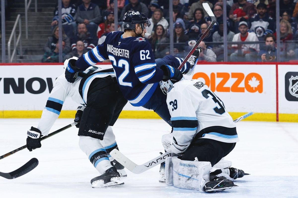 Jan 24, 2025; Winnipeg, Manitoba, CAN; Utah Winnipeg Jets forward Nino Niederreiter (62) is upended by Utah Hockey Club defenseman John Marino (6) during the second period at Canada Life Centre. Mandatory Credit: Terrence Lee-Imagn Images