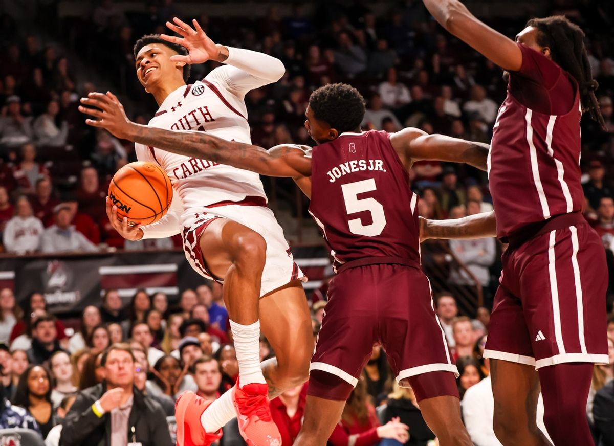 Jan 25, 2025; Columbia, South Carolina, USA; South Carolina Gamecocks guard Arden Conyers (21) attempts to get around Mississippi State Bulldogs guard Shawn Jones Jr. (5) in the first half at Colonial Life Arena. Mandatory Credit: Jeff Blake-Imagn Images