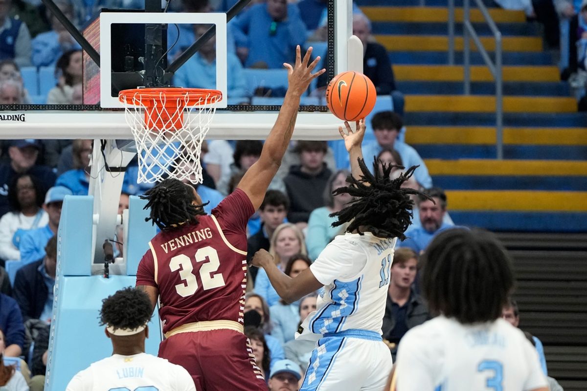 Jan 25, 2025; Chapel Hill, North Carolina, USA;  North Carolina Tar Heels guard Ian Jackson (11) shoots as Boston College Eagles forward Chad Venning (32) defends in the first half at Dean E. Smith Center. Mandatory Credit: Bob Donnan-Imagn Images