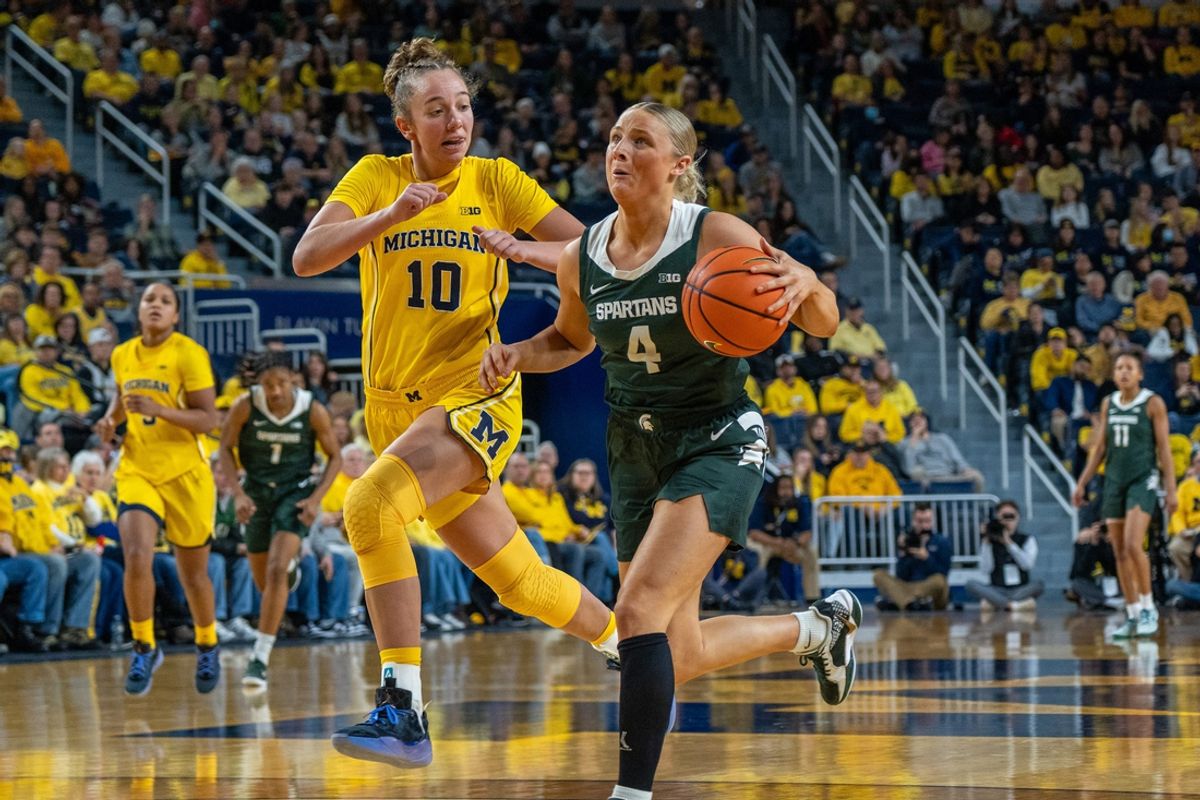 Michigan State’s Theryn Hallock (4) attempts a layup against Michigan’s Jordan Hobbs (1) during the second half of their matchup at Crisler Center in Ann Arbor on Saturday, Jan. 25, 2025.
