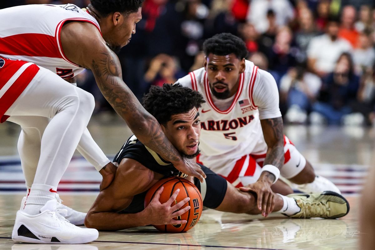 Jan 25, 2025; Tucson, Arizona, USA; Arizona Wildcats guard Caleb Love (1) and Colorado Buffaloes guard RJ Smith (5) both reach for the ball while Arizona Wildcats guard KJ Lewis (5) watches during the first half of the game at McKale Center. Mandatory Credit: Aryanna Frank-Imagn Images