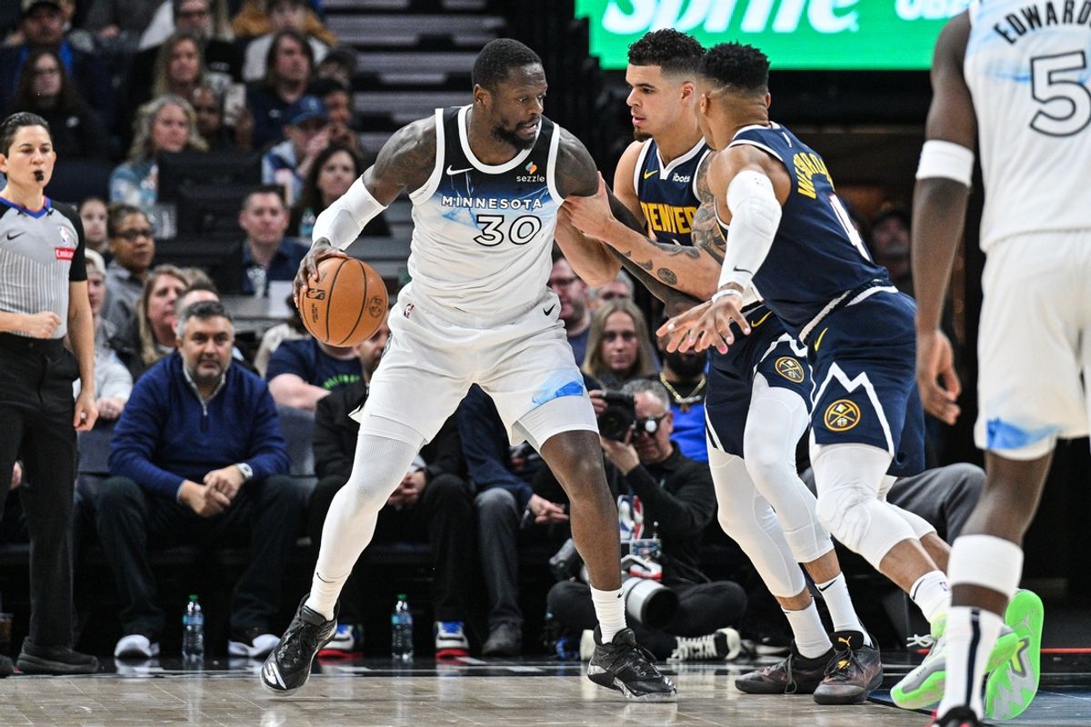 Jan 25, 2025; Minneapolis, Minnesota, USA; Minnesota Timberwolves forward Julius Randle (30) is defended by Denver Nuggets forward Michael Porter Jr. (rear) and guard Russell Westbrook (4) during the second quarter at Target Center. Mandatory Credit: Jeffrey Becker-Imagn Images