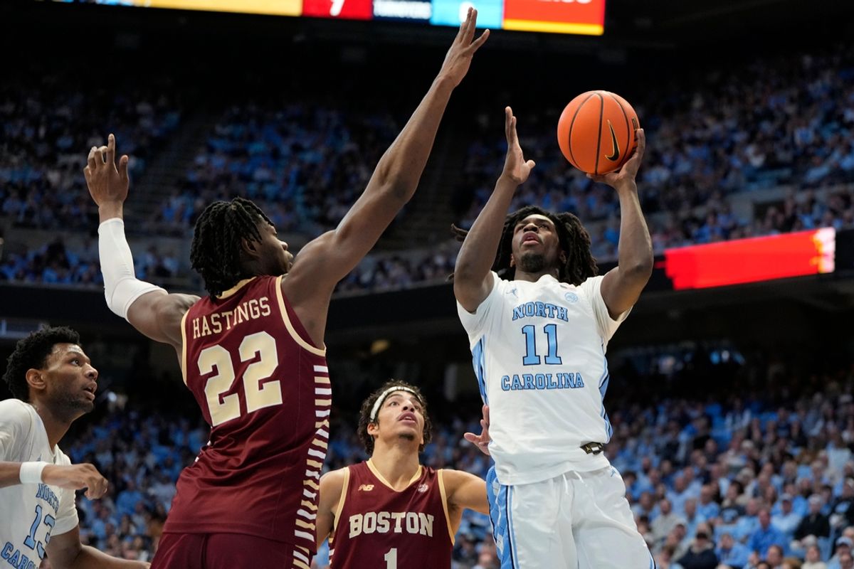 Jan 25, 2025; Chapel Hill, North Carolina, USA; North Carolina Tar Heels guard Ian Jackson (11) shoots as Boston College Eagles forward Jayden Hastings (22) defends in the second half at Dean E. Smith Center. Mandatory Credit: Bob Donnan-Imagn Images