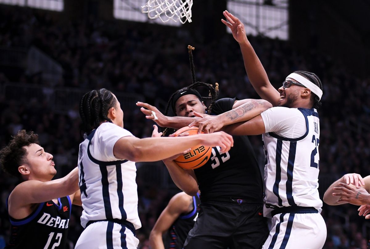 Jan 25, 2025; Indianapolis, Indiana, USA; DePaul Blue Demons forward NJ Benson (35) rebounds the ball against Butler Bulldogs center Andre Screen (23) during the first half at Hinkle Fieldhouse. Mandatory Credit: Robert Goddin-Imagn Images