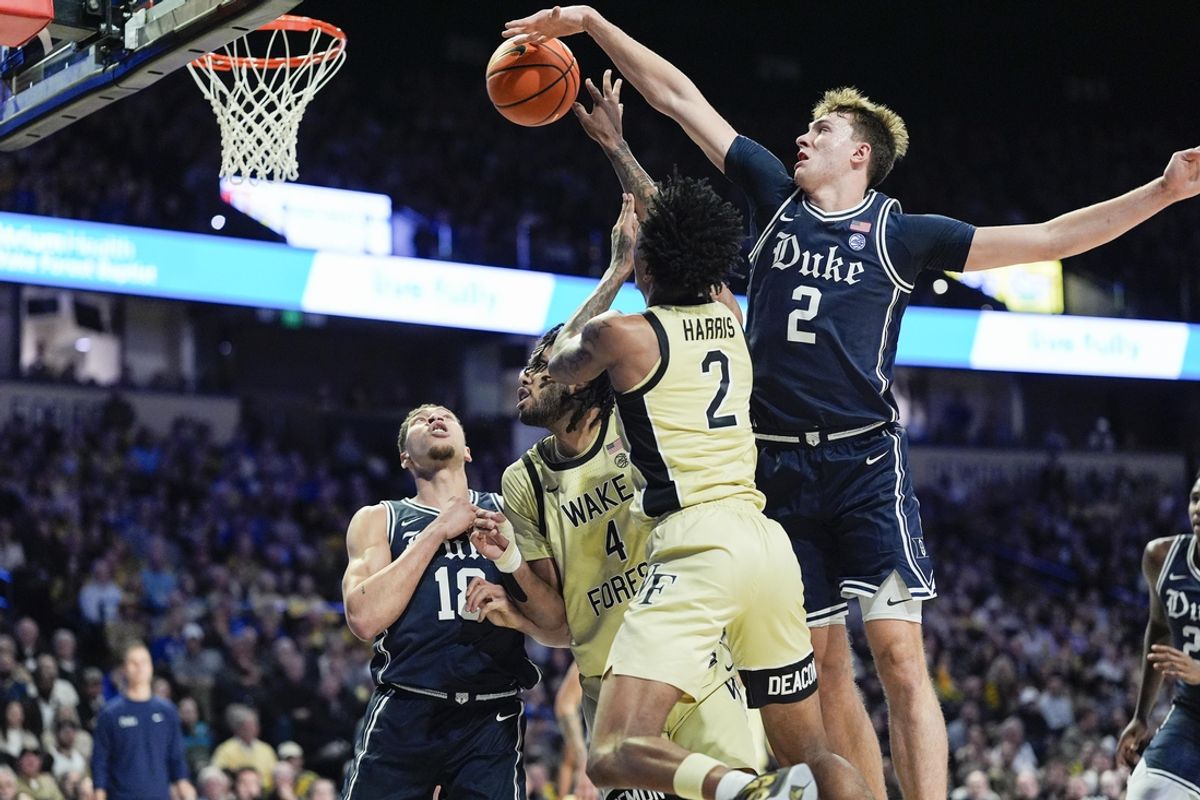 Jan 25, 2025; Winston-Salem, North Carolina, USA; Duke Blue Devils guard Cooper Flagg (2) blocks a shot by Wake Forest Demon Deacons guard Juke Harris (2) during the first half at Lawrence Joel Veterans Memorial Coliseum. Mandatory Credit: Jim Dedmon-Imagn Images