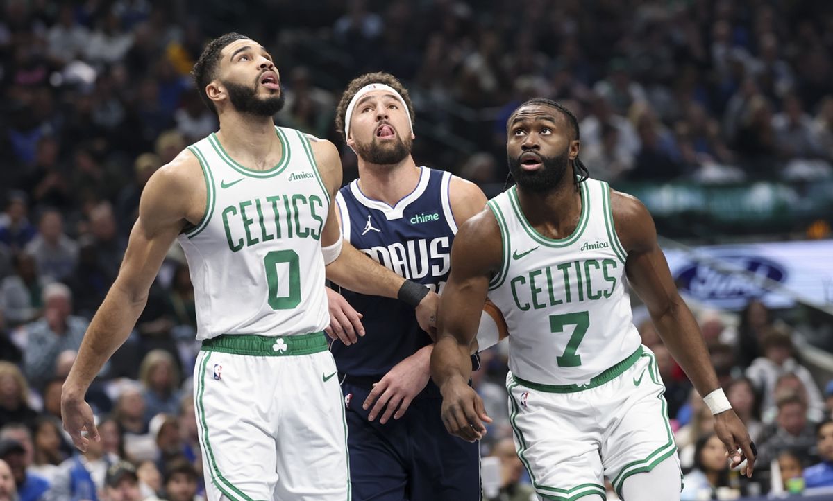 Jan 25, 2025; Dallas, Texas, USA;  Boston Celtics forward Jayson Tatum (0) and Boston Celtics guard Jaylen Brown (7) look for a rebound against Dallas Mavericks guard Klay Thompson (31) during the first half at American Airlines Center. Mandatory Credit: Kevin Jairaj-Imagn Images
