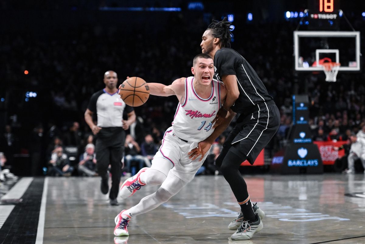 Jan 25, 2025; Brooklyn, New York, USA; Miami Heat guard Tyler Herro (14) drives past Brooklyn Nets forward Ziaire Williams (8) during the first half at Barclays Center. Mandatory Credit: John Jones-Imagn Images