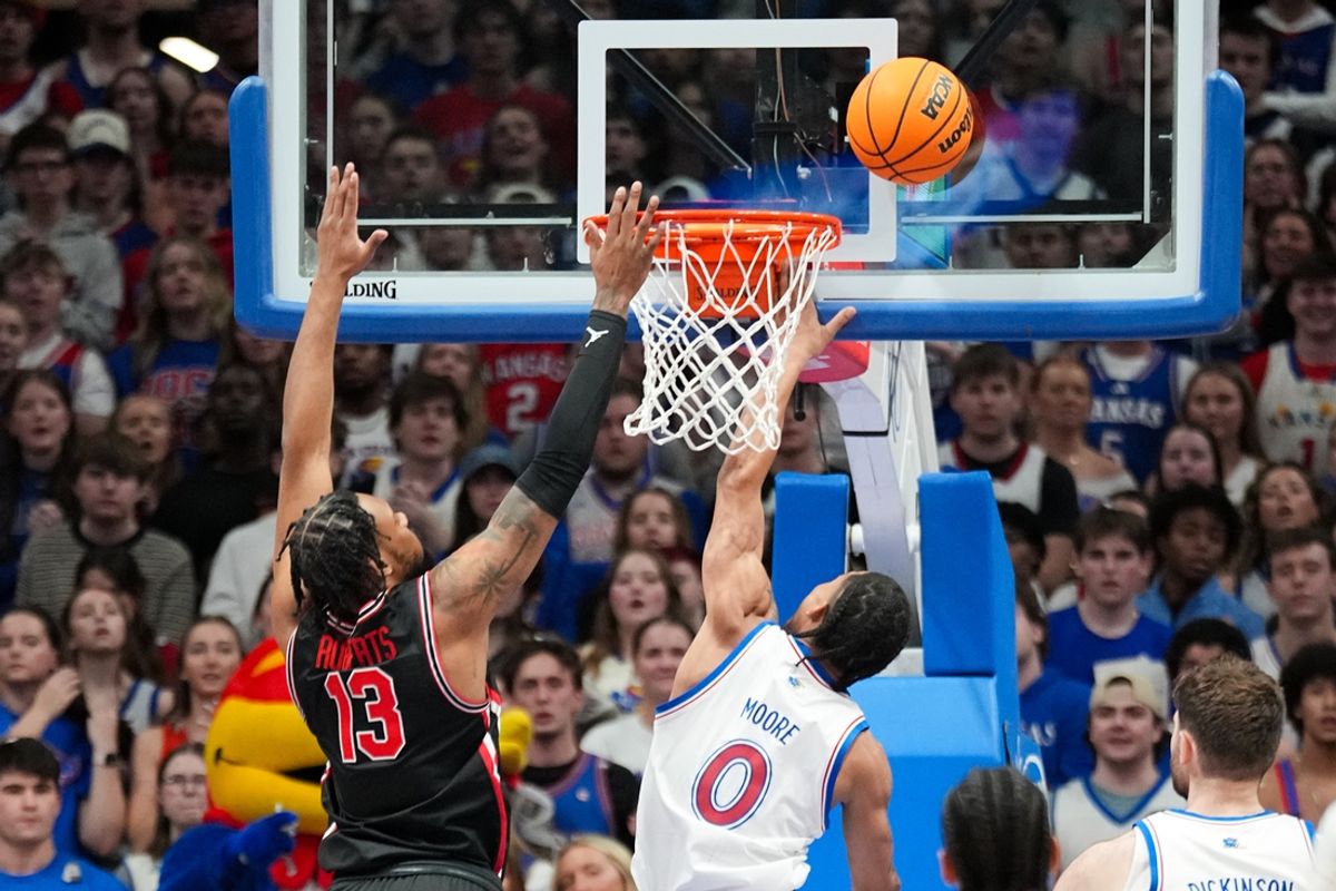 Jan 25, 2025; Lawrence, Kansas, USA; Kansas Jayhawks guard Shakeel Moore (0) shoots as Houston Cougars forward J'Wan Roberts (13) defends during the first half at Allen Fieldhouse. Mandatory Credit: Denny Medley-Imagn Images