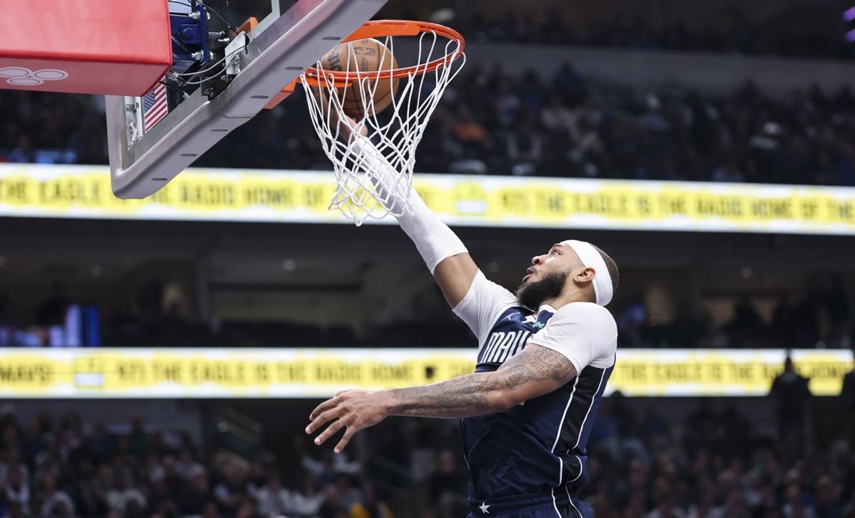 Jan 25, 2025; Dallas, Texas, USA;  Dallas Mavericks center Daniel Gafford (21) scores during the first half against the Boston Celtics at American Airlines Center. Mandatory Credit: Kevin Jairaj-Imagn Images