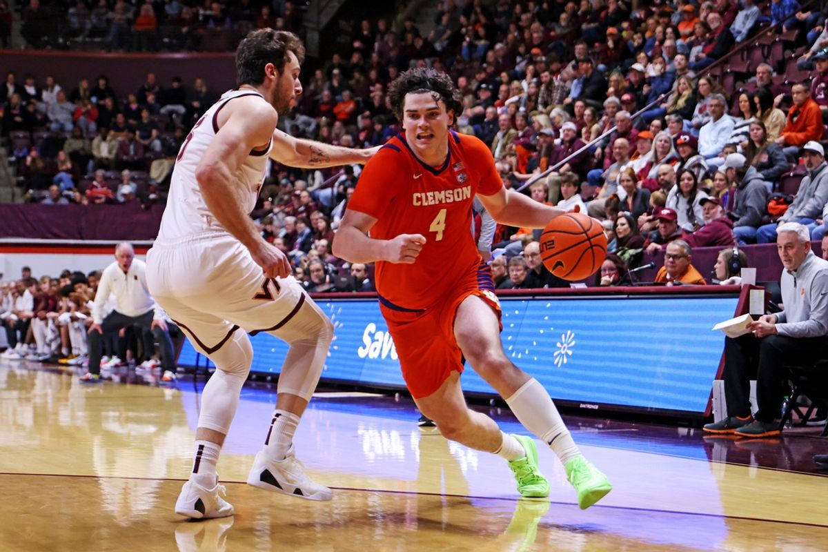 Jan 25, 2025; Blacksburg, Virginia, USA; Clemson Tigers forward Ian Schieffelin (4) drives to the basket against Virginia Tech Hokies forward Ben Burnham (13) during the second half at Cassell Coliseum. Mandatory Credit: Peter Casey-Imagn Images