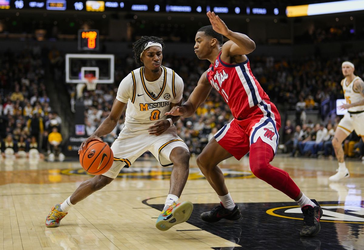 Jan 25, 2025; Columbia, Missouri, USA; Missouri Tigers guard Anthony Robinson II (0) drives against Mississippi Rebels guard Matthew Murrell (11) during the first half at Mizzou Arena. Mandatory Credit: Jay Biggerstaff-Imagn Images